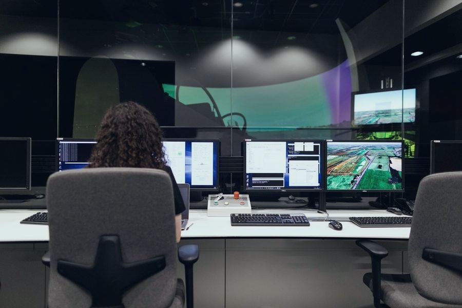 Operator at a control room desk with several monitors